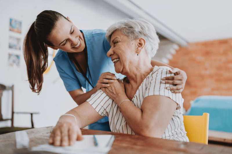 Nurse meeting with female patient for an in-home assessment.